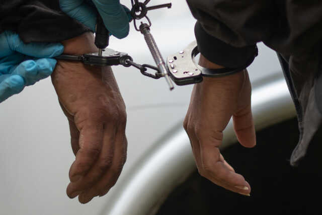 Border patrol agent takes handcuffs off men caught illegally crossing into the u.s. from mexico near mcallen, texas, u.s.